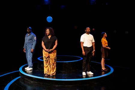 Dereks Thomas as The Astronaut, Lorraine Victoria Kanyike as Petrushka, Dom Carter as Spencer, Kalala Kiwanuka-Woernle as Esther in 'Moon Man Walk'